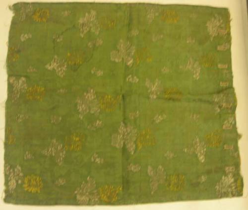 Green brocade with yellow and white flowers, with button holes
