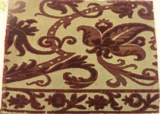Red velvet pattern on beige, worn