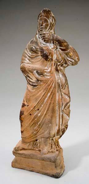 Tanagra figurine of a standing woman on a plynth