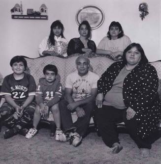 Mother, father and child in front of Christmas tree (with five kids standing), from the series "Lower West Side"