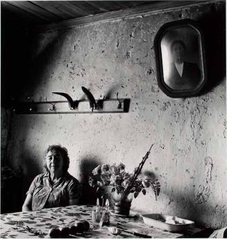 Woman sitting at table with horns, from the series "Chile"