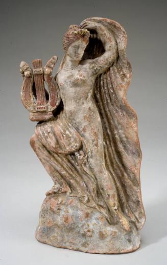 Tanagra figurine of a woman holding a lyre