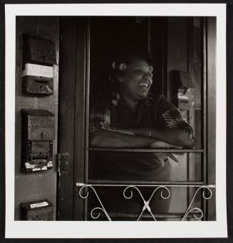 Woman laughing through screen door, from the series "Lower West Side"
