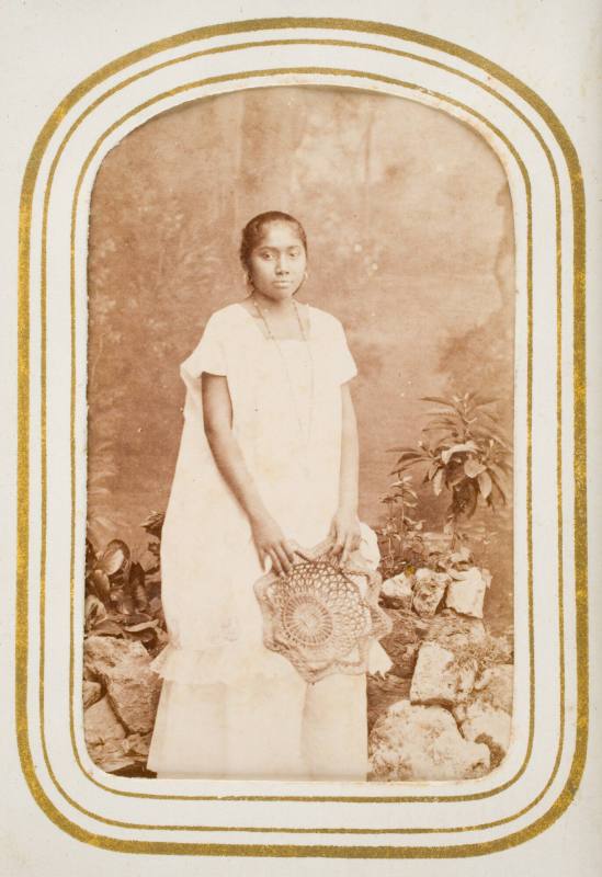 Mestiza de Yucatan [standing portrait of young girl from Yucatan holding a basket], from the album "Mexican Occupationals"