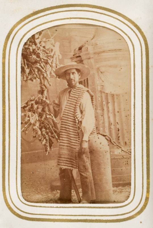 Judero [seller of Judas effigies posing in front of backdrop showing Cathedral], from the album "Mexican Occupationals"