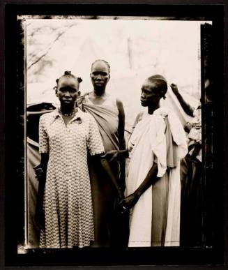Akuot Nyibol (Pregnant at center), her sister Riak Warabek and Akuot's daughter, Athok Duom, who is recovering from malaria, Sudanese refugee village, Lokichoggio, Kenya, from the series "A Sense of Common  Ground"
