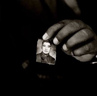 Said Ali holding a photograph of his brother, Abdul Abdi, Afghan refugee village, Khairabad, north Pakistan